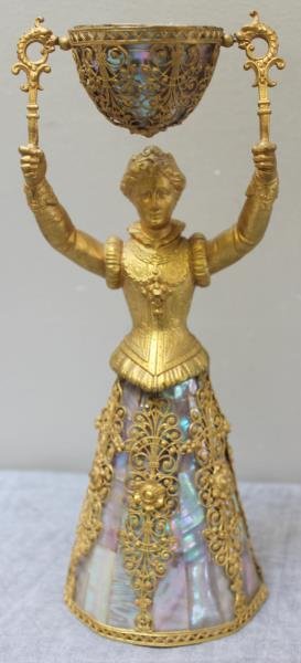 German Gilded and Abalone Shell Wedding Cup.: Standing woman with abalone bell skirt and cup, with applied filigree scroll work. From a Bronxville, NY estate. Dimensions: 3.375" diameter x 9.25" h. Condition: Good, with some lifting to filigree w