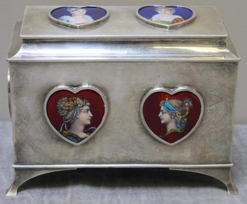 STERLING. Late 19th C Enamel Decorated Silver Box.: Beautiful casket form decorative box with 6 heart form enamel plaques depicting ladies. With a maker's mark of William Comyns & Sons, Ltd of London, with a date letter of 1898. Total approx. weight is