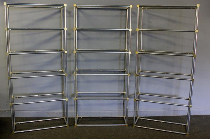 3 Midcentury Chrome and Brass Etageres.: From a Harrison, NY estate. Dimensions: 32.5" w x 13.5" d x 72.5" h. Condition: Missing one glass shelf. Center with slightly more wear to chrome.