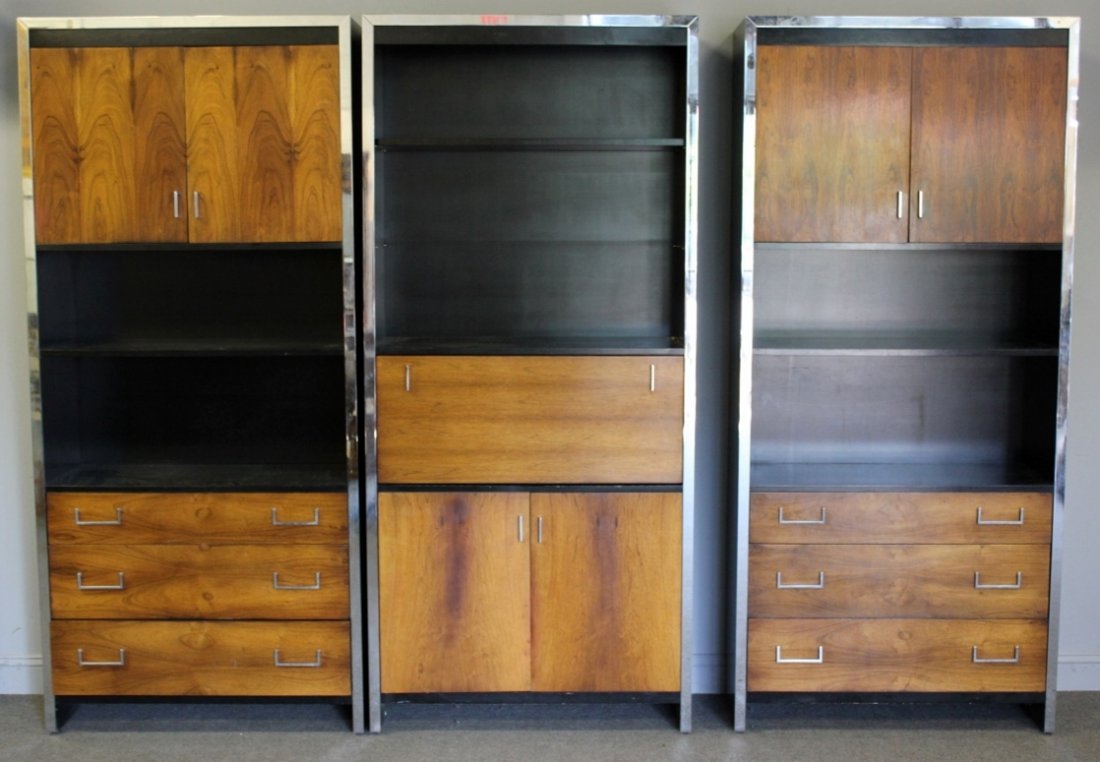 Midcentury Set of John Stuart Bookcases / Cabinets: Set of 3 chrome frame and rosewood veneer bookshelves / cabinets. Labeled John Stuart to drawer interior of center unit. From a Mamaroneck, NY estate.