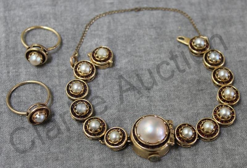 JEWELRY. 14kt Lucien Piccard Ladies Watch.: 14kt yellow gold Lucien Piccard ladies watch with individual links comprised of mabe pearls and a surround of rubies. Hidden watch face to center link. Please take note that this watch has been resize