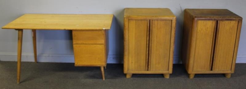 Midcentury Blondewood Lot Including Paul McCobb.: Includes unmarked Paul McCobb blondewood desk together with a pair of Heywood Wakefield stamped tambour door cabinets / end tables in wheat. From a Tuckahoe, NY estate. Dimensions: Desk - 48" w x 24" 
