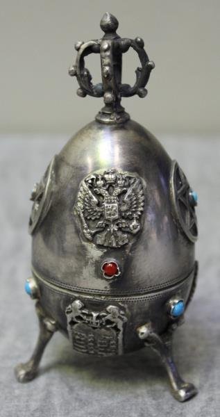 JUDAICA. Russian Silver Faberge Style Footed Egg.: Footed pedestal egg form covered box with crown finial, inlaid cabochons, and applied . Interior of egg with seated praying figure. With a Russian assay master's mark of O.C 1878 representing Josef So