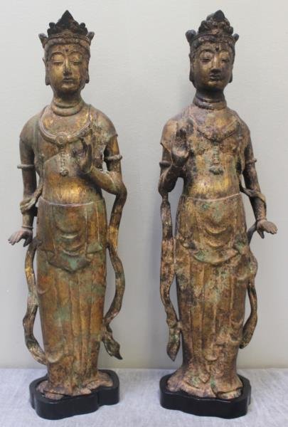 Pair of Antique/Vintage Chinese Bronze Gilded: Standing Buddha Figures. A true left and right. On conforming hardwood stands. From a Harrison, NY home. Dimensions: bronze only - 20.5" h. Condition: Good, with areas of gilt loss and oxidation to fi