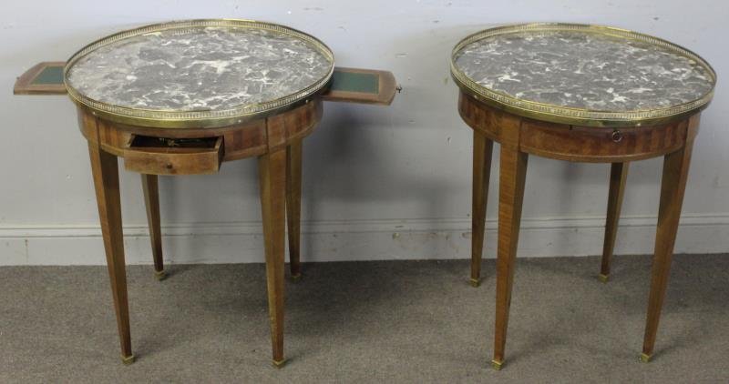 Pair of 2 Drawer Marble Top Bouillotte Tables.: With brass gallery and leather top pull outs. From a Scarsdale, NY estate. Dimensions: 24.5" diameter x 29" h. Condition: Fading to finish.