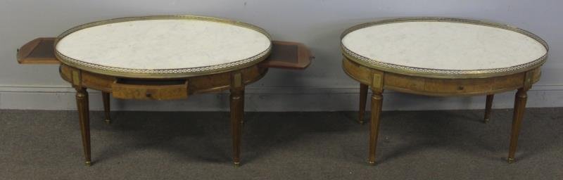 Pair of Oval Marble Top Jansen Style Builloitte: Coffee Tables. With leather top pullouts. From a Queens, NY estate. Dimensions: 35.5" w x 22" d x 20" h.
