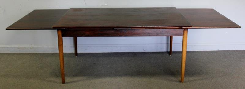 Niels Moller for Hornslet Rosewood Dining Table.: Labeled with makers stamp and Danish control button. Extension leaves to either side. From a Bronxville, NY estate. Dimensions: 62" w x 39" d x 29" h; 27.5" leaves Condition: Good with minor sun bleac