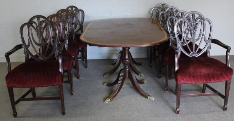 Mahogany Banded Dining Table & 8 Shieldback Chairs: A nice quality set with a box of 4 extension leaves. From a White Plains, NY estate. Dimensions: Side Chair - 23" w x 17" d x 38.5" h; Arm - 23.5" w x 22" d x 41" h; Table - 42" w x 68" d x 30" h; Lea