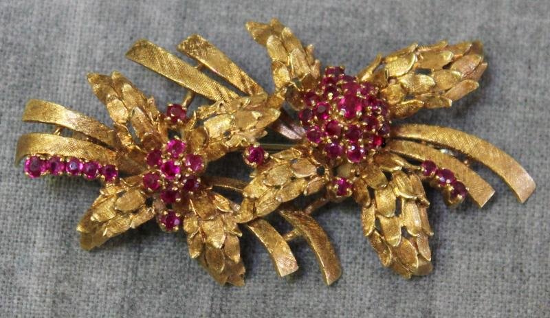 JEWELRY. Ladies 18kt and Ruby Foliate Design: Brooch. 18kt yellow gold and ruby floral and foliate design brooch. Stamped, "18kt/Italy", wih a maker's mark of "M" or "W". Total approx. weight is 7 dwt. From a White Plains, NY home. Dimensions: 2.