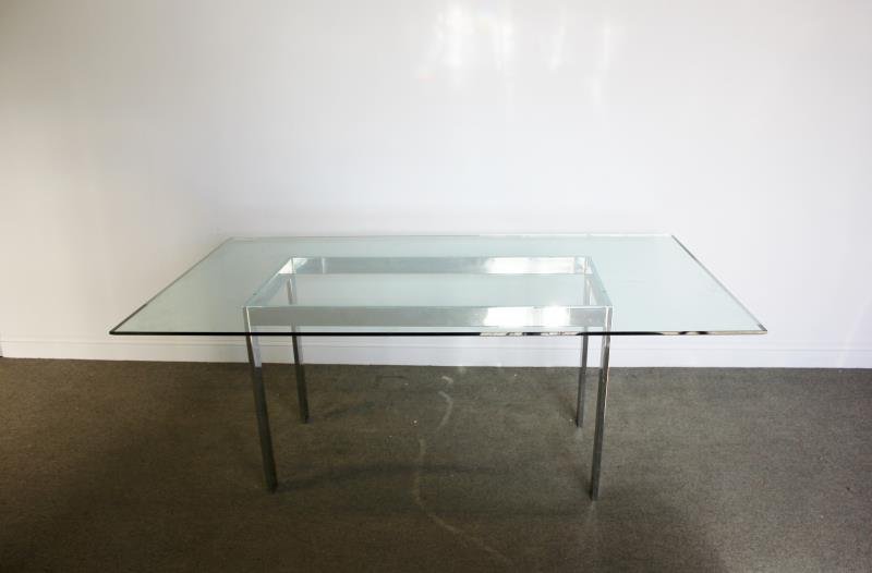 Midcentury Chrome Dining Table with Glass Top.: Simple chrome base. Heavy and thick plate glass top. From a Rye, NY estate. Dimensions: 45.5" w x 77.5" d x 29" h. Condition: Good with chip to edge of glass.