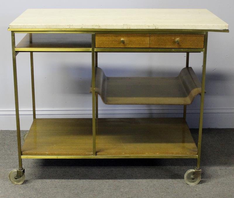 Midcentury Paul McCobb for Calvin Tea Cart.: Brass frame and travertine top. Labeled Calvin, Irwin Collection by Paul McCobb. Top labeled with Tri-Seal label. From a Scarsdale, NY estate. Dimensions: 19.25" w x 36.25" d x 29.25" h closed.