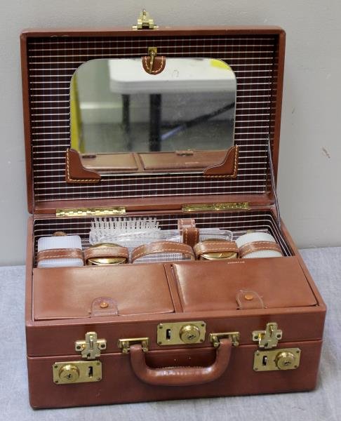Vintage Mark Cross Leather Vanity Case.: With accessories. From a Manhattan, NY estate. Dimensions: 14.5" w x 10.5" d x 6.75" h. Condition: Good, missing one makeup container.