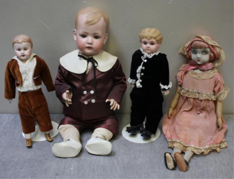4 Vintage / Antique Dolls.: Including 3 bisque or porcelain boy dolls and a doll with an embroidered face on fabric. From a Hastings-on-Hudson, NY estate. Dimensions: 12" x 18" high. Condition: Good antique condition - some pain