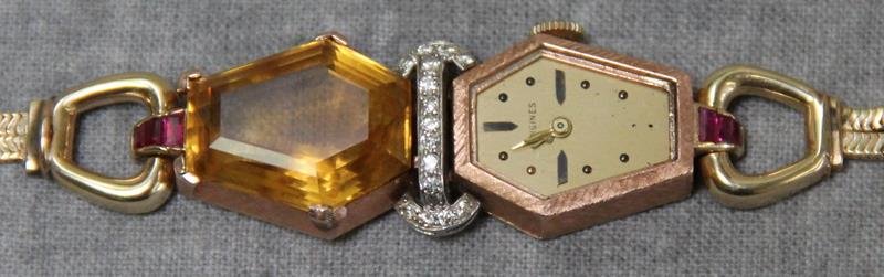 JEWELRY. 14kt Gold Longines Ladies Watch.: Unusual six-sided watch face and large "mirrored" citrine accented by diamonds and rubies set in 14kt yellow gold. Longines Watch Co. seventeen jewels movement, and serial no. 5773587. Stamped, "Lyric