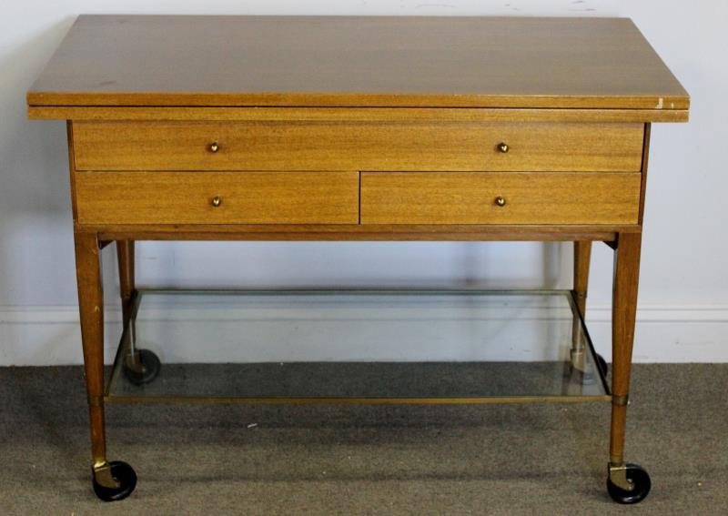 Paul McCobb for Calvin / Irwin Collection Teacart.: Midcentury. Labeled to drawer interior. Bottom glass shelf. Fold open top. From a Stamford, CT home. Dimensions: 40" w x 20" d x 29.75" h closed. Condition: Good. Some wear to table top when open.