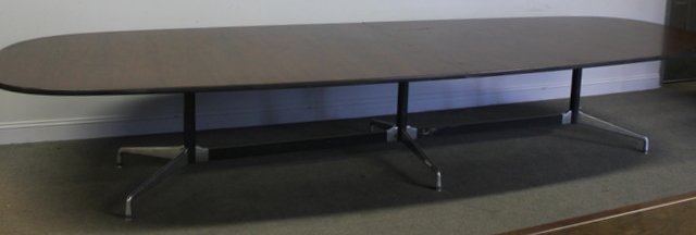 Beautiful Midcentury Rosewood Knoll Table.: Elongated conference or dining table by Knoll. Triple pedestal with unfinished rosewood to underside. From a Manhattan, NY estate. Dimensions: 168" w x 28" h. Condition: Good.