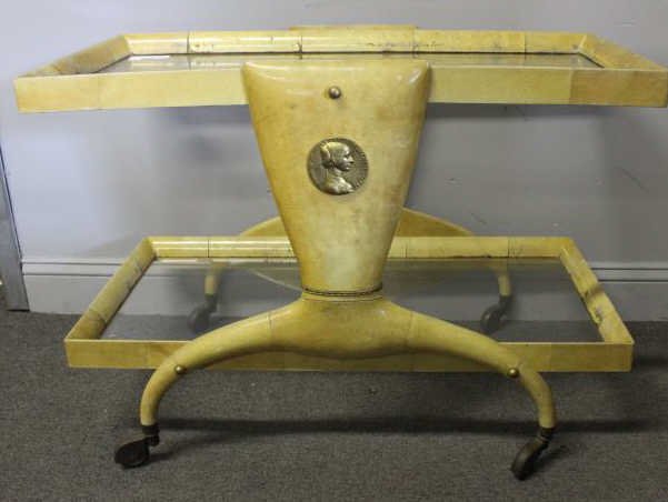 Midcentury Aldo Tura Goatskin Tea Cart.: Brass accents and applique. From an Englewood, NJ estate. Condition: With heavy wear, lacquer losses and areas of roughness. One wheel / foot loose.