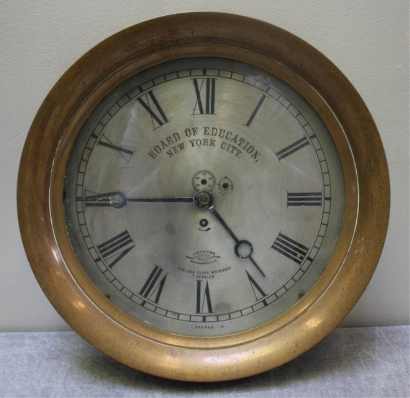 Large Brass Board of Education N.Y.C. Clock.: Brass surround with steel face. Inscribed on face Chelsea clock movement, 7 jewels, American Steam Gauge and Valve Manufg Company, Boston, Mass, U.S.A., and American Board of Education NYC. Dimensions