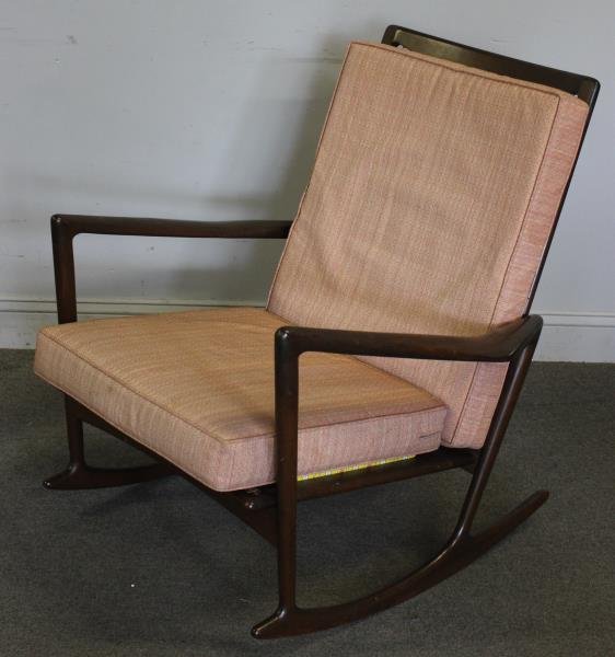 Midcentury Ib Kofod-Larsen for Selig Rocking Chair: Later custom seat and cushions. Dark patina and structurally sound. Denmark / Selig control button label to front rail. From an Englewood, NJ estate. Dimensions: 32" w x 35" d x 31.5" h. Condition: Ov