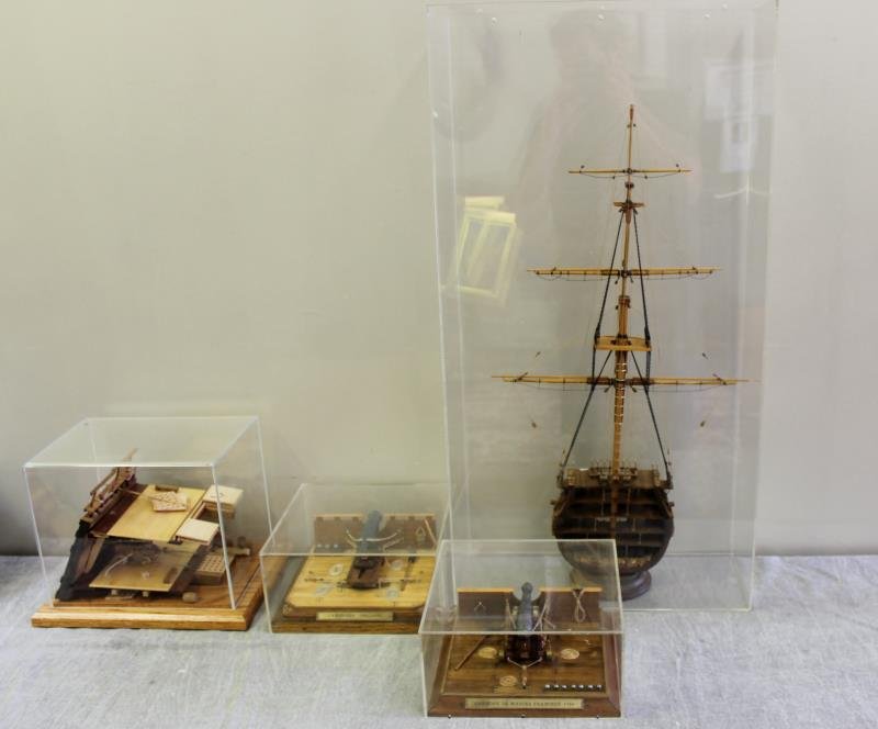 Model Ship Cross Section Lot.: Includes a pair of cannons, a deck cross section, and a mast cross section. From a Queens, NY estate. Dimensions: 14" x 27", 10.5" x 7.5" and 9.5" x 9.5."