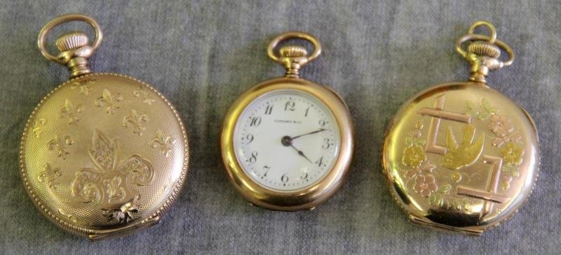 JEWELRY. Pocket Watch Grouping Including Tiffany.: Includes an 18kt yellow gold Tiffany and Co. pocket watch - with Tiffany & Co. movement, serial no. 1426824. Accompanied by an Elgin fleur de lis decorated hunter case pocket watch - with an Elgin mov