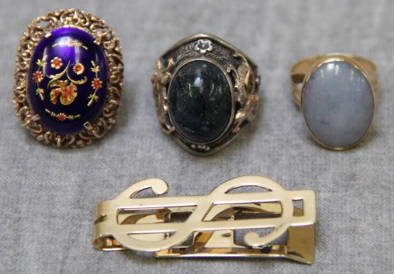 JEWELRY. Miscellaneous Gold Jewelry Grouping.: Includes a Tiffany & Co. 14kt gold money clip; a 14kt yellow gold and blue jade ring; a sterling and hardstone ring with gold dragon detailing; and a 14kt yellow gold and enamel decorated ring. Ring s