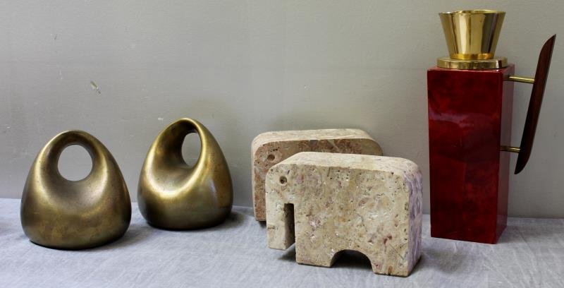 Midcentury Accessories Lot Including Ben Seibel: Bookends. Together with a set of elephant form travertine book ends, and a Aldo Tura carafe. From a Dix Hills, NY estate. Dimensions: Tura - 6" w x 11" h; Seibel - 6" w x 6" h.