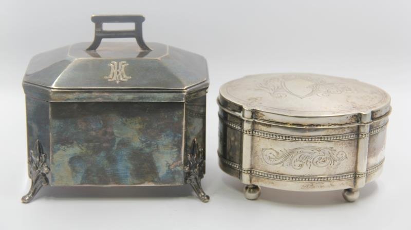 SILVER. Group of 2 Decorative Boxes.: Includes a 20th century .800 silver Polish footed box with central etched escutcheon and floral design to lid - Krakow city mark and maker's mark of JG. Accompanied by a silverplate footed casket box