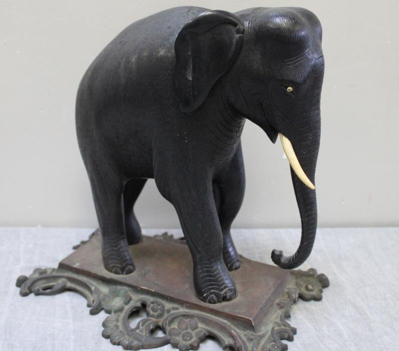 Finely Carved Ebony Elephant On Gilt Metal Base.: From a Harrison NY estate. Dimensions: 11"L x 6"D x 11"H Condition: missing 1 tusk.
