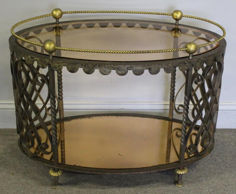 Art Deco Iron & Brass Cocktail Table with Amber: Glass Inserts. From a Harrison NY estate. Dimensions: 31" w x 17.5" d x 34" h. Condition: Good.
