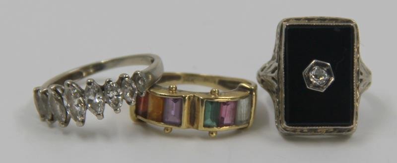 JEWELRY. Gold Ring Grouping.: Includes a 14kt white gold and marquis cut diamond band comprised of 9 diamonds graduated in size; a 14kt yellow gold and colored gem band - stamped, "14kt/MN;" and a 14kt white gold and onyx ring wit