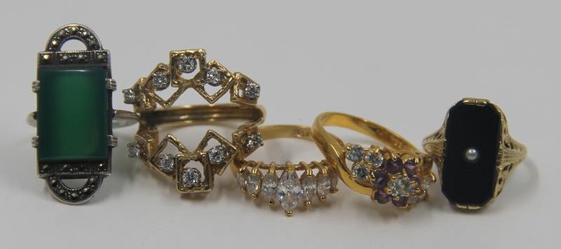 JEWELRY. Gold Ring Grouping.: Includes a 14kt yellow gold enhancer ring with diamond accents; Marcasite and glass Deco ring; a 14kt gold, onyx and seed pearl ring; a gold plated and faux diamond ring; and a rhinestone floral ring.