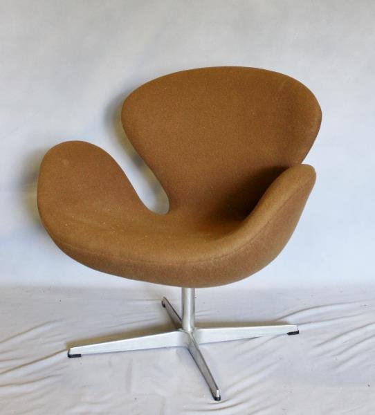 Midcentury Arne Jacobsen; Fritz Hansen Swan Chair.: Brown upholstery. Marked to base underside Fritz Hansen, Made in Denmark. From a Manhattan, NY estate. Dimensions: 30" w x 22" d x 30" h. Condition: Good.