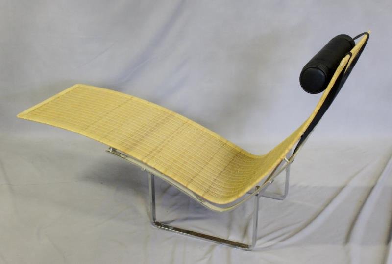 Modern Chrome and Woven Seat Chaise Lounge.: Black leather upholstered head rest. Unmarked. From a Manhattan, NY estate. Dimensions: 64" w x 21" d x 34" h. Condition: A couple areas of puncture losses to weave.