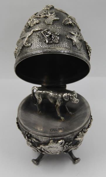 SILVER. 19th C Russian Silver Egg Form Box.: Footed egg form box with applied moose heads, boar's heads, ducks, stag heads, and oak leaves with acorns. Box opens to reveal a standing dog. With an assay master's mark of Josef Sosnkowski - Warsaw,