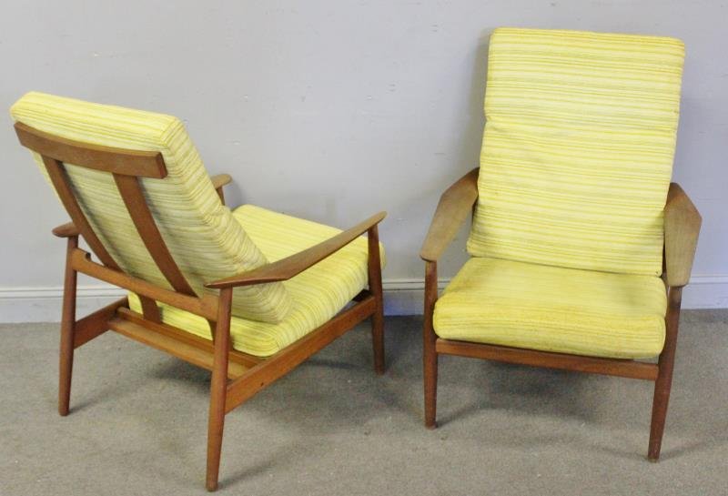 Pair of Arne Vodder; France & Sons Lounge Chairs.: Midcentury chairs labeled France and Sons, John Stuart. Teak frames and vintage cushions. Adjustable with wide paddle arms and tapered legs. From a Long Island, NY estate. Dimensions: 31" w x 32" d x