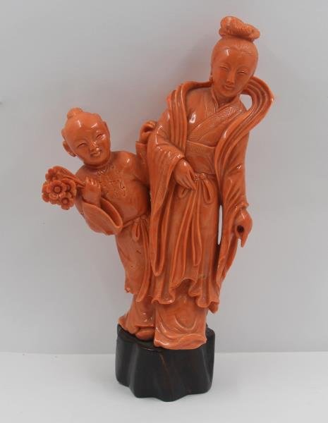 Beautifully Carved Coral Standing Figure of a Quan: Yin with Child. On wood stand. From a Long Island, NY estate. Dimensions: 6.5" h excluding base. Condition: Good, with glue residue to base and base of figures.