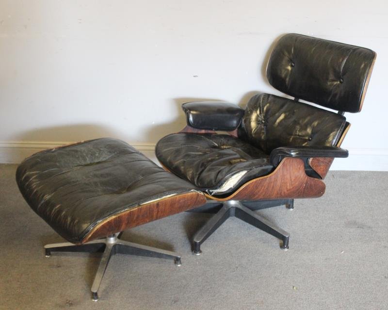 Midcentury Eames 670 / 671 Lounge Chair & Ottoman.: Rosewood case Ray & Charles Eames lounge chair, together with an as is ottoman. From a New Rochelle, NY estate. Dimensions: 33.5" w x 34" d x 30" h; 26" w x 21" d x 17.5" h. Condition: Cushions as is