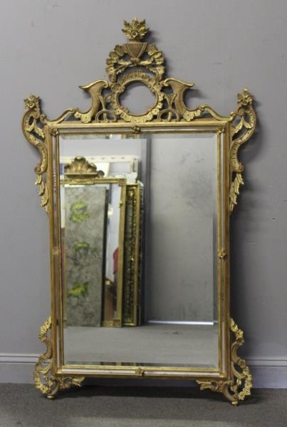 Italian Carved and Giltwood Mirror.: From a Harrison, NY estate. Dimensions: 36" w x 59" h. Condition: good, old repair to top, missing 1 flower.