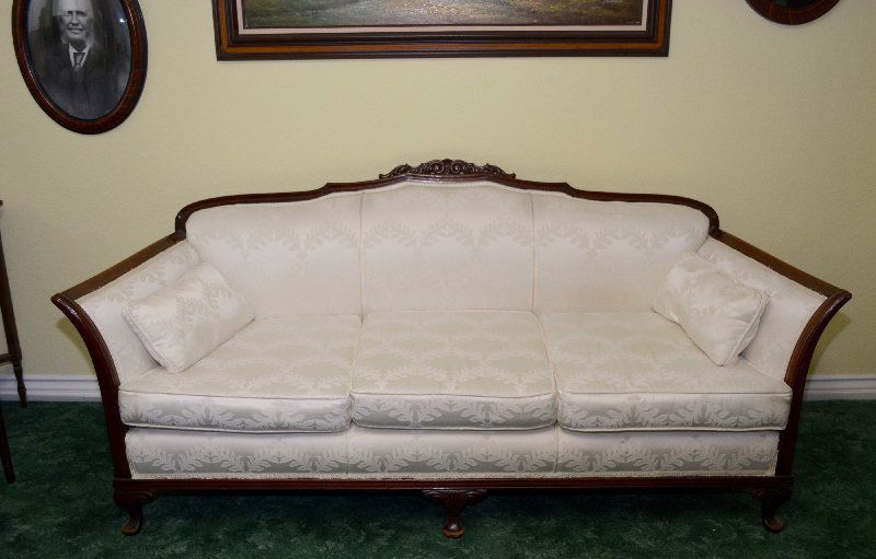 Duncan Phyfe Sofa, Rolled Arms: Period sofa with rolled arms, wood back rail, carved front legs on brass paw castors, matching pair with the armchair, size is 34" tall (from floor to couch) l x 26" deep x 75 wide.