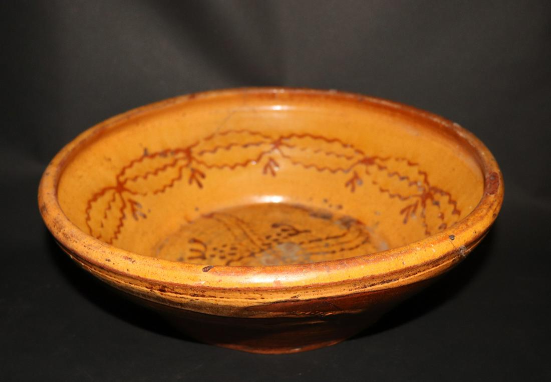19th C. French Terracotta Redware Bowl: 19th century or earlier French yellow slip redware bowl. 13.5" in diameter x 4.5" HNew York Antiques Market 1990s