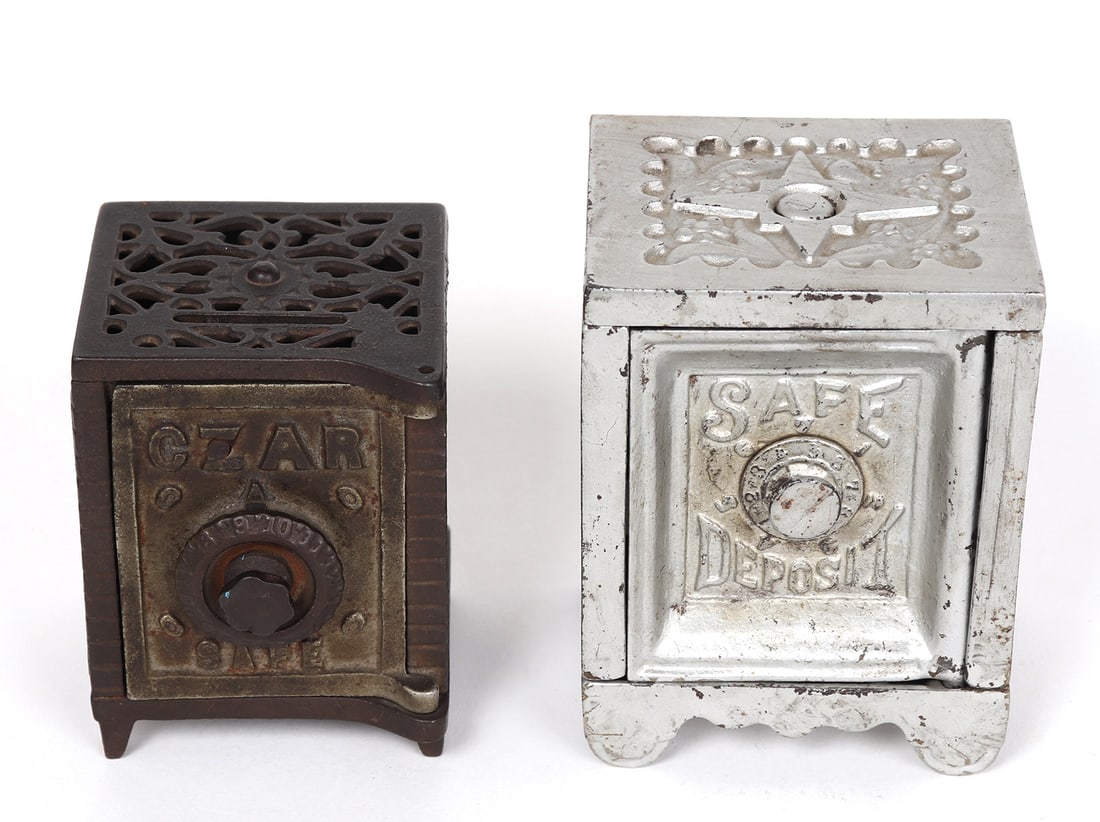 Pair of Cast Iron Coin Banks: Two twist lock safes, one with CZAR to the face, the other Safe Deposit to the front. Size of largest 4" H x 3" W