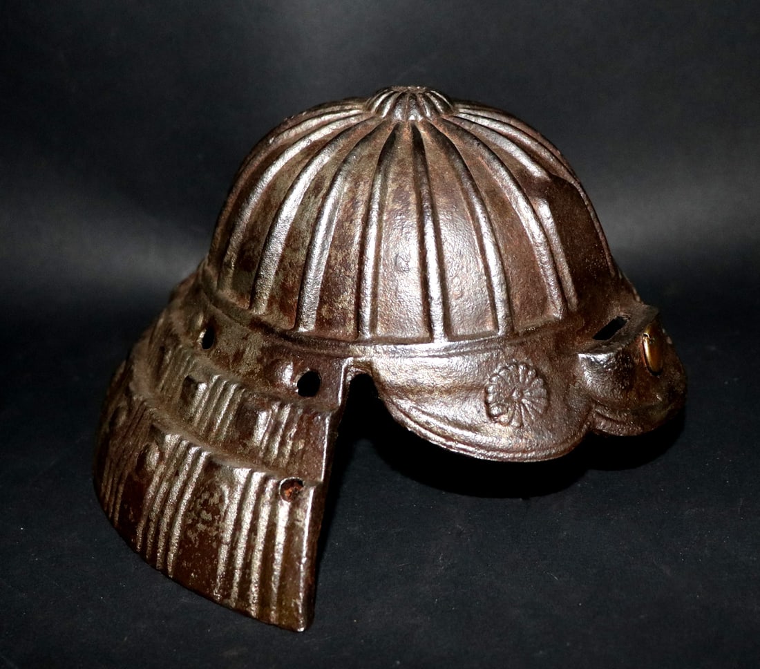 Antique Iron Kabuto Miniature: Miniature Japanese iron "Kabuto" helm heavily worn featuring floral rondel symbols and embossed stylization. 4" H x 7.5" HPrivate California arms collector