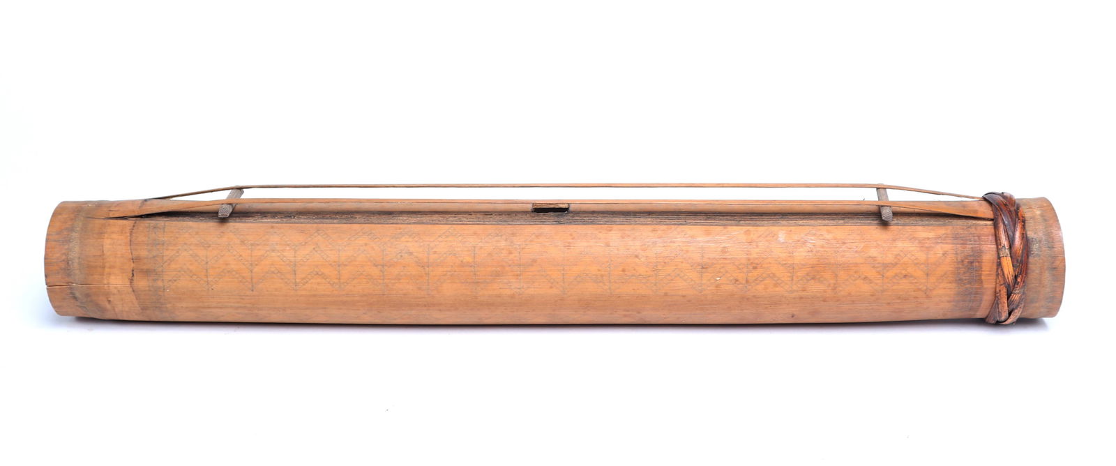 Filipino Bamboo Zither, Hand Guitar: Beautifully incised bamboo zither with braided rattan. Wheat stock like designs to the body, with caramel colored rattan braiding to one end. Zithers are typically played by strumming or plucking the