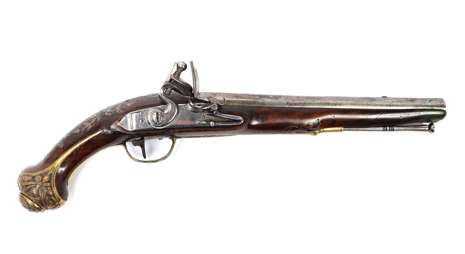 Silver Inlaid Miquelet Flintlock Pistol: Well made and finely inlaid silver wire miquelet flintlock pistol. Brown wood stock, small green dyed section to barrel section probably bone. All steel original ramrod. Gilt brass embossed mounts thr