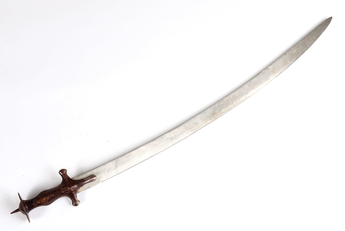 Old Indian Pulwar Sword: Old Indian pulwar sword with flat disc pommel and central spike and plain iron handle formed in a single piece of iron. Size 35 1/2" L, blade 30 3/4" LSouthern California arms collector