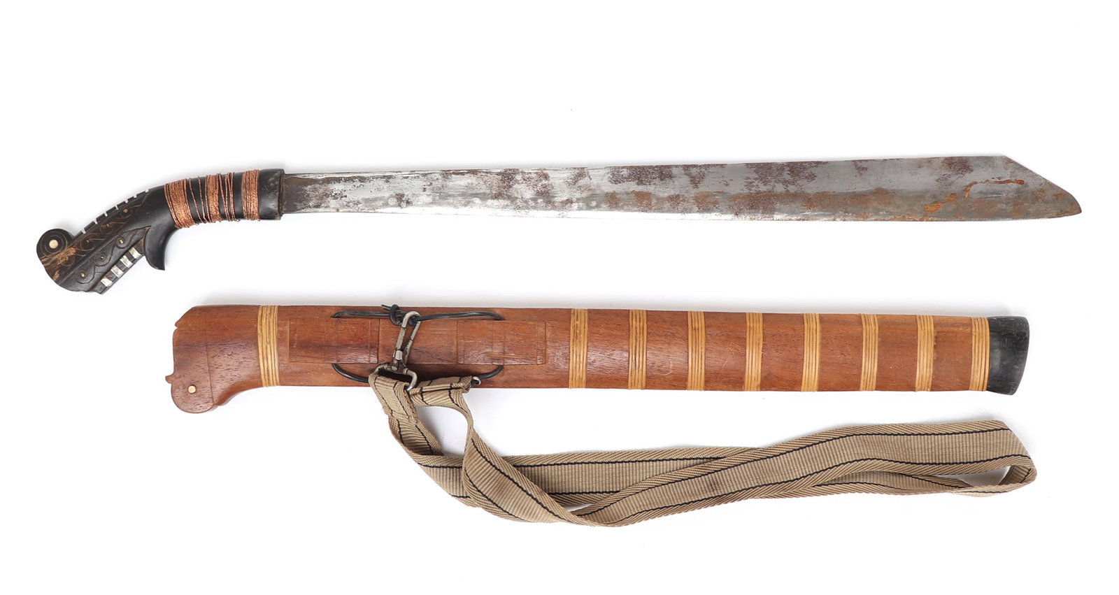 Good Balato Sword w/ Scabbard: Indonesia, Nias Islands. Good Balato sword with scabbard and belt. The handle in characteristic form wood carved with metal wrapped decoration and copper pins emulating an animal head. Engraved illegi