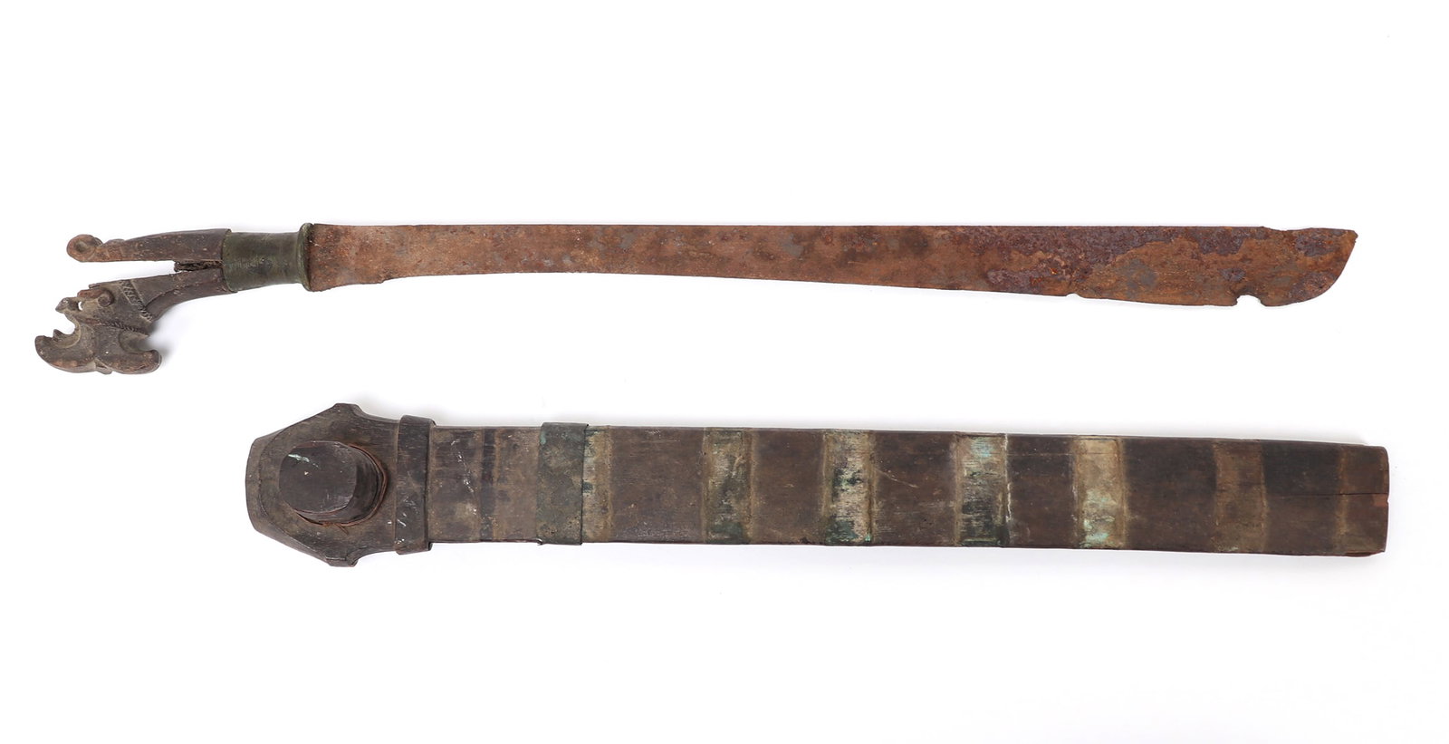 Indonesian Balato Sword with Scabbard: Large Balato sword with scabbard with carved features to handle. Scabbard loose, missing metal bands which hold it together, split and loss to wood handle, blade rusted and chipped. Size 23 1/2" L, bl