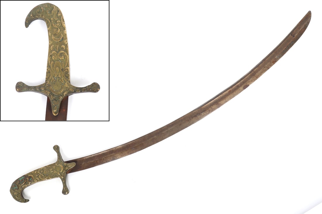 Ottoman Shamshir Sword: Late ottoman shamshir sword with a long slender curved blade that is single edged and features a wide low fuller. The handle cast in brass with floral decoration and crescent moons. Size 33" L overall