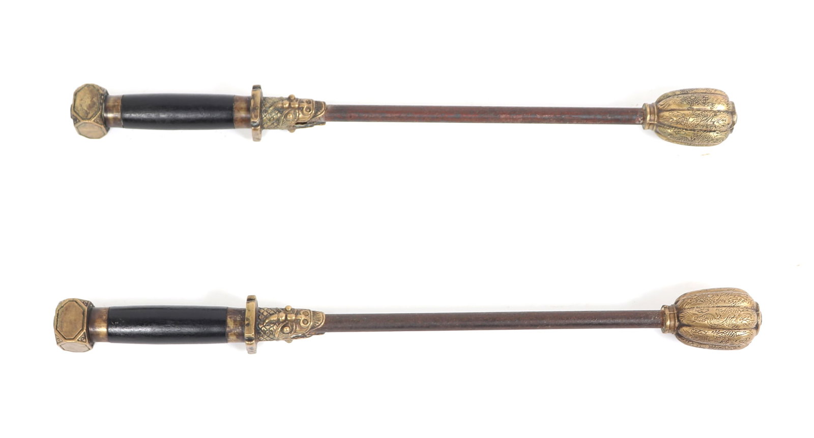 Pair of Chinese Iron & Brass Maces: Pair of Chinese heavy maces known as Assassin's Chui with brass hardware and a heavy multi-lobed mace ball in brass and a stee shaft to a guard with agape foo dog heads in brass. The grip in ebonized 